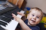 Small Boy Enjoys Playing Electric Piano Stock Photo