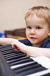 Small Boy Enjoys Playing Electric Piano (synthesizer) Stock Photo