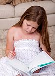 Small Girl Studying In Home Stock Photo