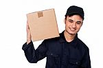 Smart Courier Boy With Parcel On Shoulders Stock Photo