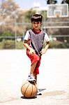Smart Kid Holding Basketball Under His Leg Stock Photo