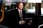 Smart Young Businessman Inside Taxi Cab Stock Photo