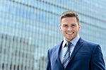 Smart Young Businessman Looking At Camera Stock Photo