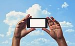 Smartphone In Hand And Blue Sky Stock Photo