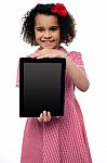 Smiling African American Girl Presenting Tablet Pc Stock Photo