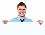 Smiling Businessman Holding Board Stock Photo