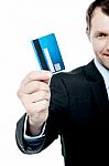 Smiling Businessman Holding Credit Card Stock Photo