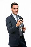 Smiling Businessman Holding Mobile Phone Stock Photo