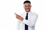 Smiling Businessman Pointing Away Stock Photo