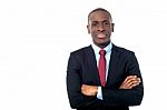Smiling Businessman With Arms Crossed Stock Photo