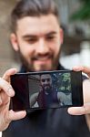 Smiling Casual Man Taking A Selfie Stock Photo