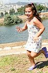 Smiling Caucasian Girl Running Stock Photo