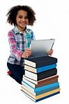 Smiling Child Busy With Tablet Pc And Books Stock Photo