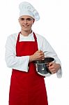 Smiling Confident Chef Holding Vessel Stock Photo