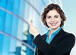 Smiling Corporate Lady Pointing Away Stock Photo
