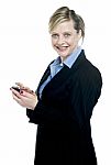 Smiling Corporate Lady Using Cellphone Stock Photo