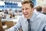 Smiling Corporate Man At Restaurant Stock Photo