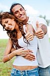 Smiling Couple Showing Thumbs Up Stock Photo