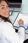Smiling Doctor Holding Pen And Looking At Camera Stock Photo