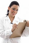 Smiling Doctor Writing On Clipboard Stock Photo
