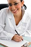 Smiling Doctor Writing Prescription Stock Photo