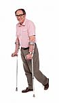 Smiling Elderly Man With Crutches Stock Photo
