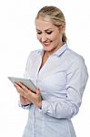Smiling Female Executive Working On Tablet Stock Photo