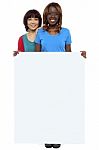 Smiling Friends Holding Blank Board Stock Photo