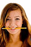 Smiling Girl Biting Pencil Stock Photo