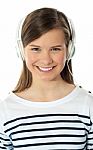 Smiling Girl Enjoying Music Stock Photo