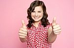Smiling Girl Showing Thumbs Up Stock Photo