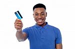 Smiling Guy Holding Credit Card Stock Photo