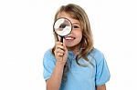 Smiling Kid With Magnifying Glass Stock Photo