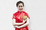 Smiling Lady Holding Golden Heart Stock Photo