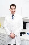 Smiling Male Doctor Posing In Lab Coat Stock Photo