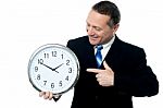 Smiling Man Holding A Clock In His Hands Stock Photo