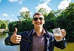 Smiling Man Holding A Large Beer Mug Stock Photo
