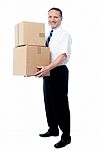 Smiling Mature Man Carrying Boxes Stock Photo
