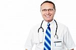 Smiling Middle Aged Doctor In Lab Coat Stock Photo