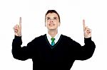Smiling School Boy Pointing Up Stock Photo