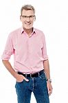 Smiling Senior Man With Hand In His Pocket Stock Photo