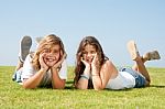 smiling sibling Lying In lawn Stock Photo
