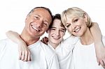Smiling Son Hugging His Mother And Father Stock Photo