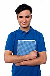 Smiling Student Embracing His Note Book Stock Photo