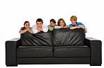 Smiling Teenage Friends With Sofa Stock Photo