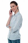 Smiling Woman Attending Phone Call Stock Photo