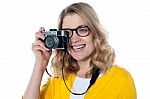 Smiling Woman Holding Camera Stock Photo