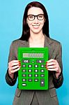 Smiling Woman Showing Calculator Stock Photo