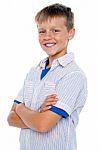 Smiling Young Boy With Crossed Arms Stock Photo