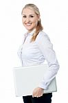 Smiling Young Corporate Woman With Laptop Stock Photo